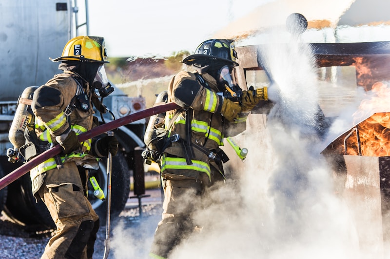 Volunteer firefighters working together during a daytime drill